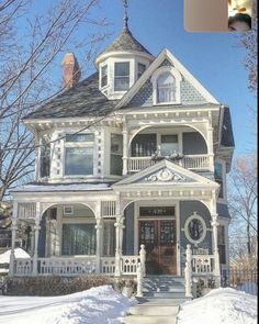 a large white house sitting on top of snow covered ground