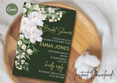 a green and white floral bridal shower card on a wooden platter with cotton