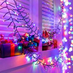 christmas lights and presents are on the window sill