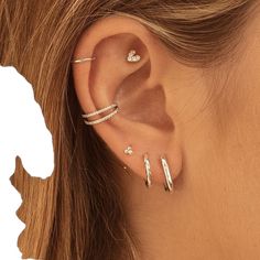 a woman's ear with three different types of piercings on the top and bottom