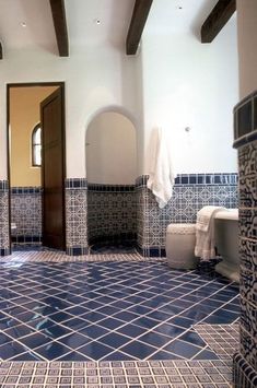 a bathroom with blue and white tiles on the floor