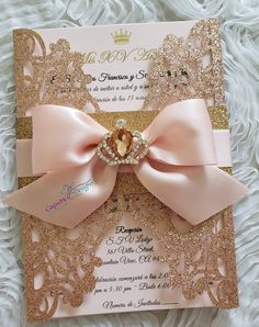 a pink and gold wedding card with a large bow