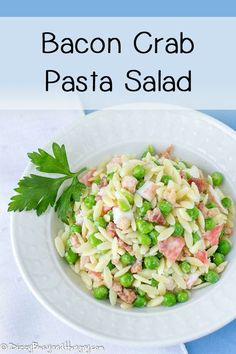 a white bowl filled with pasta and peas