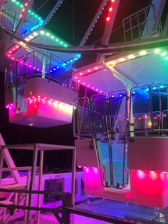 the inside of a boat with colorful lights on it's sides and railings