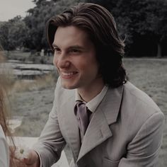 a man in a suit and tie shaking hands with a woman