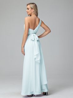 the back of a woman wearing a light blue dress with a bow at the waist