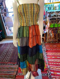 a mannequin wearing a multicolored dress on display