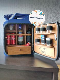 an open lunchbox sitting on top of a wooden table next to a bottle opener