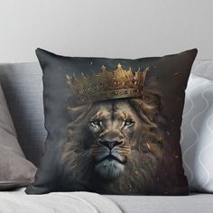 a lion with a crown on its head sitting on top of a couch throw pillow