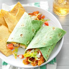 two burritos on a plate with salsa and tortilla chips