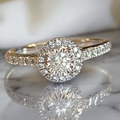 a diamond ring sitting on top of a table