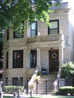 an old victorian house with wrought iron fence