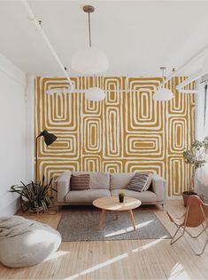 a living room with yellow and white wallpaper