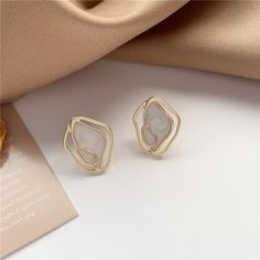 Looking for a show stopper? We've got you covered. Check out these gorgeous and super stylish statement earrings. Material: Metal. Elegant Irregular Jewelry For Party, Trendy Plated Earrings, Modern Irregular Jewelry, Elegant Irregular Shaped Earrings Gift, Trendy Irregular Shaped Metal Jewelry, Trendy White Metal Clip-on Earrings, Enamel Stud Earrings, Round Dangle Earrings, Geometric Studs