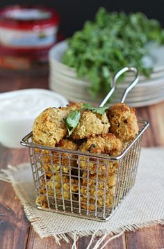 some food in a metal basket on a table