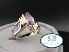 Previously Loved🥰Not New 👑Vintage Amethyst Ring👑 Engagement Ring w/ Channel Set Baguette Amethyst (8pcs) A FABULOUS Vintage Treasure Built in all Glowing 14k Yellow Gold ✨️ Featuring a FANTASTIC Amethyst Statement Ring Design. Set with a Beautiful Marquise Cut Genuine Amethyst 🟣 Gemstone center, measuring in at approximately 5x10mm with more Baguette Cut Genuine Purple Amethyst Gemstones  Channel Set on  both sides. This AMAZING Vintage Amethyst Ring is PERFECT on its own and a STATEMENT wit Amethyst Baguette Cut Rings For Anniversary, Baguette Cut Amethyst Anniversary Rings, Fine Jewelry Amethyst Ring Baguette Cut For Anniversary, Anniversary Amethyst Baguette Cut Ring, Baguette Cut Amethyst Ring For Anniversary, Anniversary Baguette Cut Amethyst Ring, Vintage Amethyst Rings, Vintage Amethyst Ring, Amethyst Rings