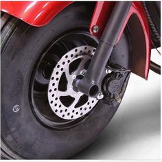 the front wheel of a red motorcycle on a white background