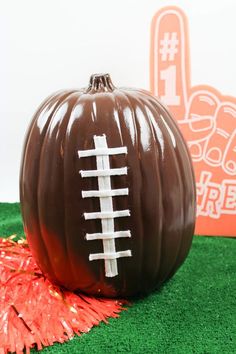 a chocolate pumpkin with a football painted on it