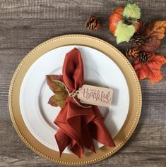 a white plate topped with a red napkin and an orange napkin on top of it