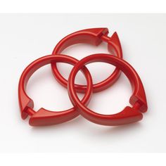 three red plastic rings on a white surface