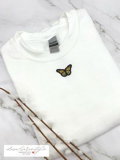 TRENDY BUTTERFLY EMBROIDERY UNISEX CREWNECK SWEATSHIRT - Made to order - Ships Worldwide from California, USA - Fast Shipping - Butterfly embroidery Sweatshirt Details: * Unisex crew neck sweatshirt sizes run big, please size down if you want a more fitted look * Soft and comfortably Gildan Brand * Air jet yarn = softer feel and reduced pilling * 8 oz.(US)50/50 preshrunk cotton/polyester * Heather Sport colors: 60/40 polyester/cotton * Double needle stitching at shoulder, armhole, neck, waistban Butterfly Sweatpants On Amazon, Nike Embroidered Sweatshirt Butterfly, Custom Nike Sweatshirt Butterfly, Butterfly Nike Sweatshirt, Butterfly Sweater, Sweatshirt Details, Moreno Valley, Little Butterfly, Embroidered Butterfly