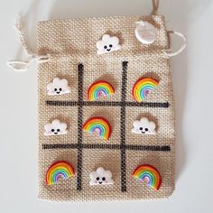 a small bag with buttons on it that have bears and rainbows in them,