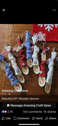 several snowman themed wooden spoons are on the floor next to a red and white towel