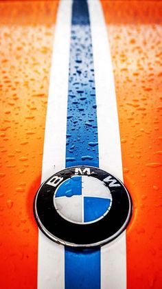 an orange and blue car with the bmw logo on it's front bumper strip