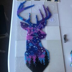 a piece of art made out of legos is shown with the image of a deer's head