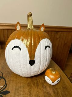 a pumpkin shaped like a fox sitting on top of a table