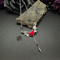 Embrace this Valloween with this mesmerizing Devilish Heart Necklace. This piece is sure to enhance those little devil, gothic vibes in your look. Enhance your gothic look further and pair with our earrings and chokers. Happy Valloween!Devilish Heart Necklace Details: Fashion Jewelry ~ Handmade Stainless Steel Chain & Spike Chain Length: 47cm or 18.5" + 2" extender Pendant: 54mm x 34mm Spike Dangle Length: 70mm Punk Metal Necklaces For Cosplay, Punk Metal Necklace For Cosplay, Punk Style Metal Necklace For Cosplay, Edgy Metal Necklace For Halloween, Punk Style Necklace For Halloween Gift, Vampire Style Necklaces For Halloween Cosplay, Edgy Halloween Necklaces For Alternative Fashion, Edgy Halloween Necklace For Alternative Fashion, Edgy Halloween Choker Necklace