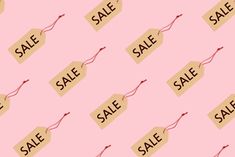 a pink background with sale signs on it