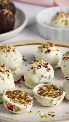 several desserts are on a plate with white frosting and sprinkles