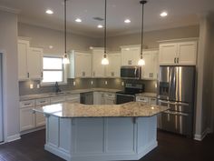 a large kitchen with an island in the middle