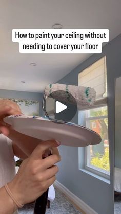 a woman is holding a plate with the words how to paint your ceiling without needing to cover your floor