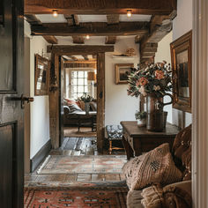 a living room filled with lots of furniture and flowers on top of a wooden table