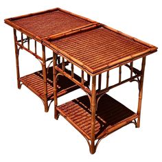 a table made out of bamboo and wicker with two shelves on each side for storage