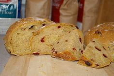 two loaves of bread sitting on top of a wooden cutting board