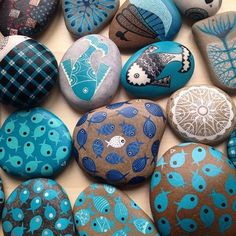 many different colored rocks with designs on them