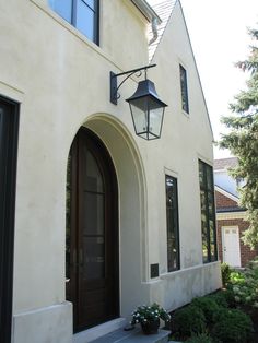 a light hanging from the side of a white house