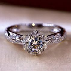 a close up of a diamond ring on a table