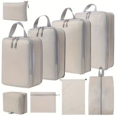 four pieces of white luggage with zippers on each side and two bags in the middle