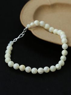 This elegant necklace showcases simplicity at its finest, featuring smooth white shell beads delicately strung together. The minimalist design exudes a timeless charm, perfect for both casual and formal occasions. With its versatile style, this necklace effortlessly complements any outfit, adding a touch of sophistication to your look. Metal: 18K Recycled Gold Plated On Brass Gemstone: Mother of Pearls(6.5mm/8mm/12mm) 6.5mm/8mm Bead Chain Length: 400mm 12mm Bead Chain Length: 390mm Weight: 26.5/