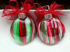 two red and green ornaments on a white plate