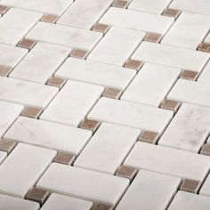 a close up view of a white and brown mosaic tile