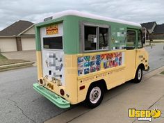 a yellow and green food truck parked on the side of the road in front of a house