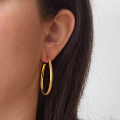 Minimal brushed gold vermeil oval hoop earrings. Simple oval shaped gold vermeil hoops, with matt and shiny contrast detail and a stud fitting.  Dimensions (approx): * Length: 4cm  * Width: 2.5cm  * Thickness: 3mm  Materials:  * Gold Vermeil  Beyond Biasa creates unique jewellery that is inspired by antique and tribal designs from around the globe. All of our pieces are handmade so please allow for slight variations in size and colour. Gold Oval Hoop Earrings Minimalist Style, Gold Oval Minimalist Hoop Earrings, Gold Minimalist Oval Hoop Earrings, Minimalist Gold Oval Hoop Earrings, Gold Hammered Oval Hoop Earrings, Gold Oval Hammered Hoop Earrings, Minimalist Gold Plated Oval Hoop Earrings, Gold Hammered Hoop Earrings, Minimal Gold