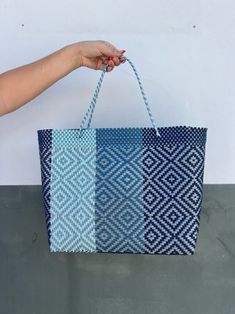 This beautiful recycled plastic tote is handwoven in Oaxaca, Mexico. Each bag has one-of-a-kind colors and patterns. Water resistance and malleable. Perfect for any occasion. The perfect Mexican handwoven tote! Recycled & Sustainable. This Eco Friendly handwoven tote features sleek single plastic handles. Sophisticated and handcrafted by women in Oaxaca, Mexico. This tote is constructed from recycled plastic and is the perfect size for a laptop, beach accessories or any daily necessity when you' Eco-friendly Handwoven Summer Beach Bag, Eco-friendly Rectangular Woven Beach Bag, Mexican Woven Bags, Mexican Plastic Woven Bags, Mexican Purse, Eco-friendly Multicolor Woven Bag, Daily Necessities, Recycled Plastic Bags, Beach Accessories