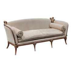 an antique style couch with two arm rests