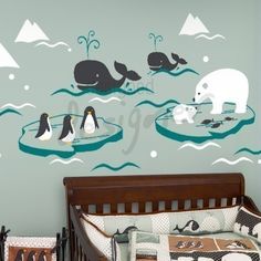 a baby's room with an animal themed wall decal and crib bedding